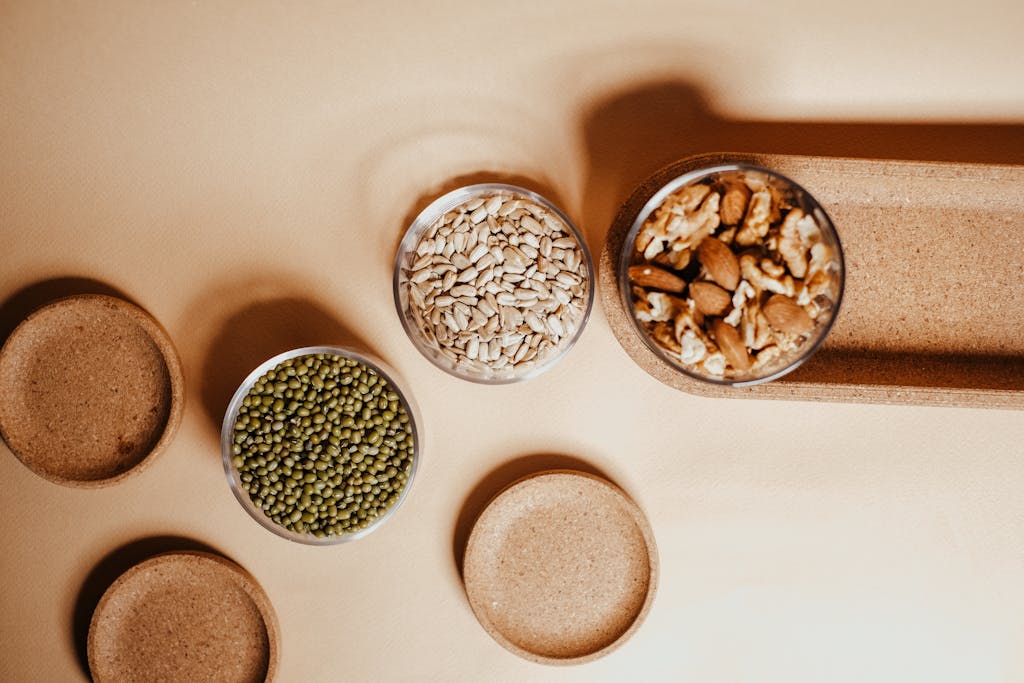 Counter with Bowls of Pea and Sunflower Seeds Next to a Jar of Almonds with Wallnuts